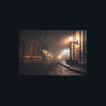 Foggy Victorian Cobblestone Alley Glow Leinwanddruck<br><div class="desc">Thick fog envelops a narrow Victorian cobblestone alley lit by warm amber street lamps mounted on elegant wrought-iron brackets. Tall Georgian brick buildings with tall windows rise on both sides, their details softened by the mist that turns every light into a glowing halo. The curving lane fades into impenetrable darkness,...</div>