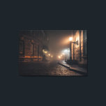 Foggy Victorian Cobblestone Alley Glow Leinwanddruck<br><div class="desc">Thick fog envelops a narrow Victorian cobblestone alley lit by warm amber street lamps mounted on elegant wrought-iron brackets. Tall Georgian brick buildings with tall windows rise on both sides, their details softened by the mist that turns every light into a glowing halo. The curving lane fades into impenetrable darkness,...</div>