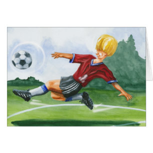 Footballeur donnant un coup de pied une boule par