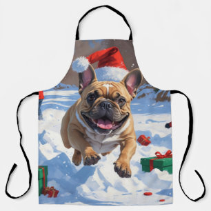 Französische Bulldogge läuft im Schnee mit Weihnac Schürze