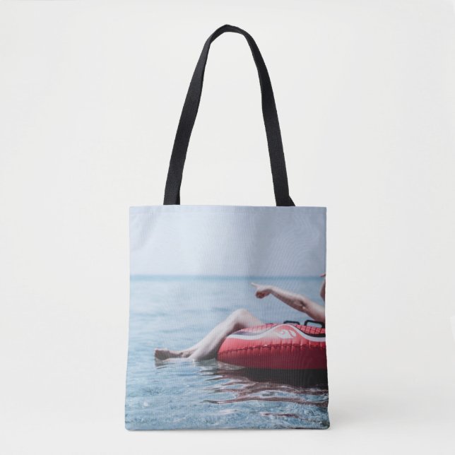 Frau auf einem aufblasbaren Schwimmer im Ozean, de Tasche (Vorderseite)