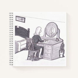 Frau sitzt an einem Schreibtisch im Schlafzimmer m Notizbuch