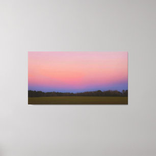 Friedlicher Sonnenuntergang über der Wiese Leinwanddruck