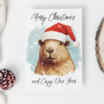 Frohe Weihnachten Capybara Karte<br><div class="desc">Dieses Design kann durch Auswahl der Option Design bearbeiten personalisiert werden. Sie können auch auf andere Gegenstände übertragen. Kontaktieren Sie mich unter colorflowcreations@gmail.com oder nutzen Sie die Chat-Option oben auf der Seite, wenn Sie dieses Design auf einem anderen Produkt haben möchten oder Hilfe bei diesem Design benötigen. Sehen Sie mehr...</div>