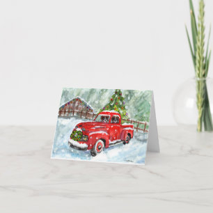 Fröhliche Weihnachtswelpen, die roten LKW fahren Karte