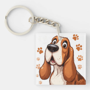 Fröhlicher Basset-Hund mit orangen Pfotenabdrücken Schlüsselanhänger
