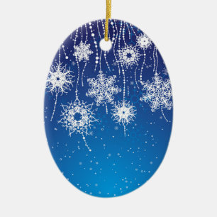 Funkelnde baumelnde Schneeflocken auf Blau Keramikornament