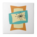 Funky Squeezed Rectangle Mitte des Jahrhunderts Fliese<br><div class="desc">Diese trendige,  moderne Keramik-Kachel aus der Mitte des Jahrhunderts weist rechteckige,  gepresste Formen in den Farben Türkisblau,  Creme und Orange auf. Sternexplosion Akzente in Rosa,  Blau,  Gold und Schwarz heben das Design hervor. Fügen Sie diesen trendigen Retro-Akzent Ihrem Tiling-Projekt hinzu!</div>