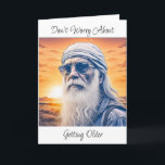 Funny Old Age Spaß Geburtstag Karte<br><div class="desc">Der sonnige alte Hippie- oder Biker-Typ mit langem Bart und Bandanna auf dem Kopf mit Sonnenuntergang im Hintergrund. Geburtstag alternder Spaß auf der Karte. "Mach dir keine Sorgen,  dass du älter wirst,  du wirst immer noch dumme lustige Sachen machen,  nur langsamer."</div>