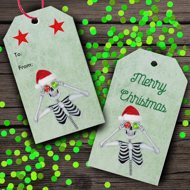 Funny Skeletto Ornament Eyes Rote Sterne Grün Geschenkanhänger (Silly Skeleton ornament eyes Santa Hat red stars on green hanging Christmas gift tags.)