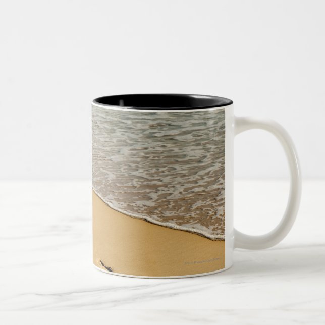 Fußdrucke im Sand mit Welle Zweifarbige Tasse (Rechts)