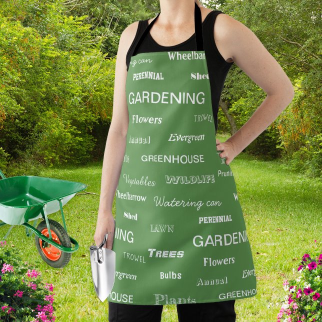 Gartenwörter Gemustert Stilvoll Grüner Garten Schürze (A stylish apron for garden lovers, patterned with gardening related words on a green background)
