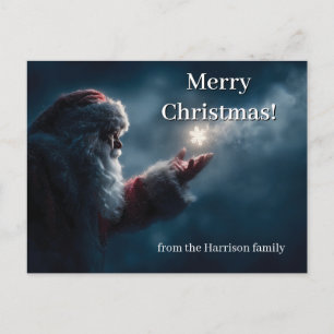 Geheimnisvoller Weihnachtsmann pustet eine leuchte Postkarte