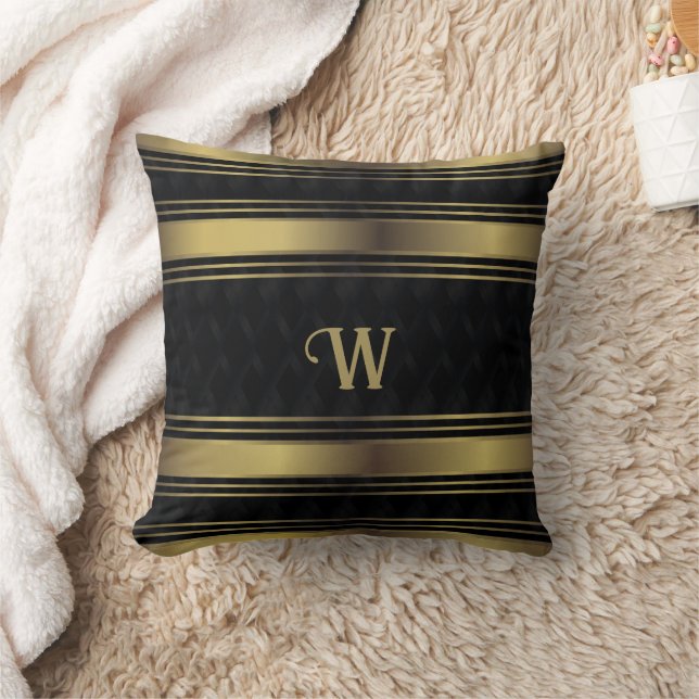 Geometrisches Monogramm aus schwarzen und goldenen Kissen (Decke)