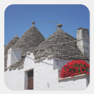 Geranium Blume und Trulli Häuser in Alberobello Quadratischer Aufkleber