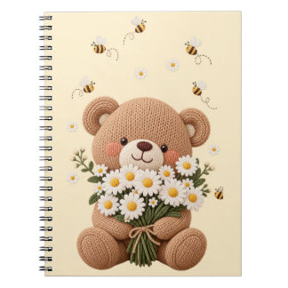 Gestrickter Teddybär mit Gänseblümchenstrauß und s Notizblock