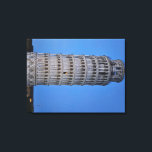 Gift Bag Leinwanddruck<br><div class="desc">This captivating photograph showcases the iconic Leaning Tower of Pisa standing elegantly against a deep blue twilight sky in Pisa. The historic marble tower, famous for its unmistakable tilt, is beautifully illuminated, highlighting its intricate Romanesque arches and layered columns. The soft evening light creates a striking contrast between the glowing...</div>