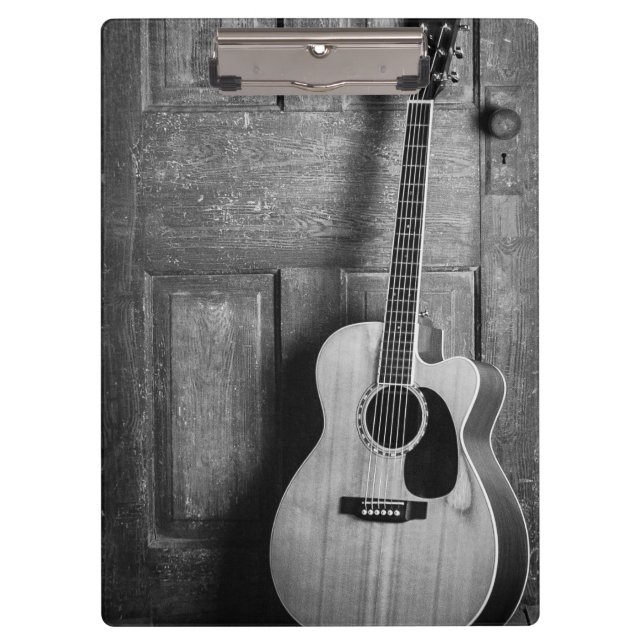 Gitarre lehnt gegen Tür in Schwarz und Weiß ab Klemmbrett (Vorderseite)
