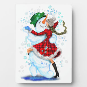 Glücklicher Schneemann und Mädchen tanzen Tango We Fotoplatte