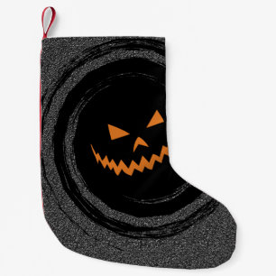 Glühender Jack O'Lantern Halloweens in einem Kleiner Weihnachtsstrumpf