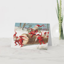 Gnomes dragging a cut tree trunk through the snow