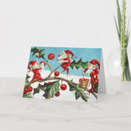 Gnomes painting holly berries in the snow karte