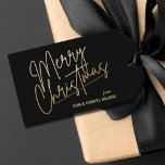 Gold Merry Christmas Luxe Black Geschenkanhänger<br><div class="desc">Frohe Weihnachten in einem Imitat goldene Folie Skript und Ihre Namen in schicken Schriften,  diese schwarzen Geschenketiketten oder Gastgeschenk Tags sind stilvoll für jeden Weihnachtsfeiertag.</div>