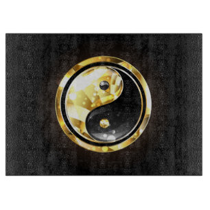 Gold Yin Yang auf schwarz Schneidebrett