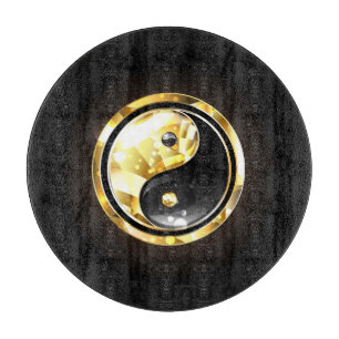 Gold Yin Yang auf schwarz Schneidebrett