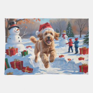 Goldendoodle läuft im Schnee mit Weihnachtsmütze Geschirrtuch