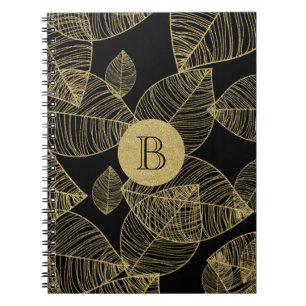 Goldene Blätter auf schwarzem eleganten Notizbuch  Notizblock