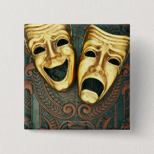 Goldene Komödien- und Tragödiemasken auf Button