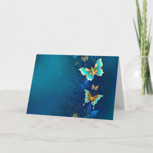 Goldene Schmetterlinge auf blauem Hintergrund Einladung