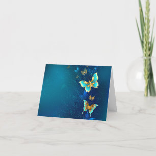 Goldene Schmetterlinge auf blauem Hintergrund Feiertagskarte