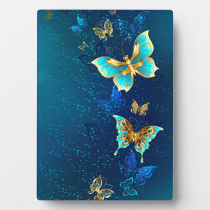 Goldene Schmetterlinge auf blauem Hintergrund Fotoplatte