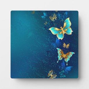 Goldene Schmetterlinge auf blauem Hintergrund Fotoplatte