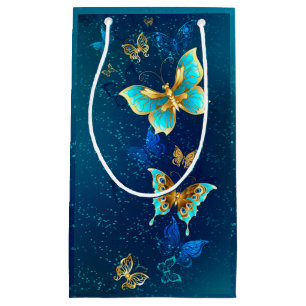 Goldene Schmetterlinge auf blauem Hintergrund Kleine Geschenktüte