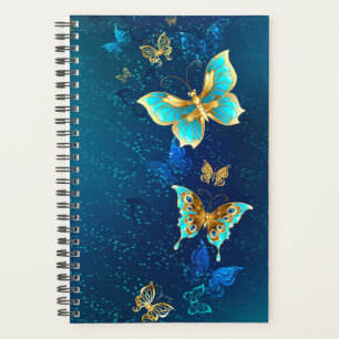 Goldene Schmetterlinge auf blauem Hintergrund Planer