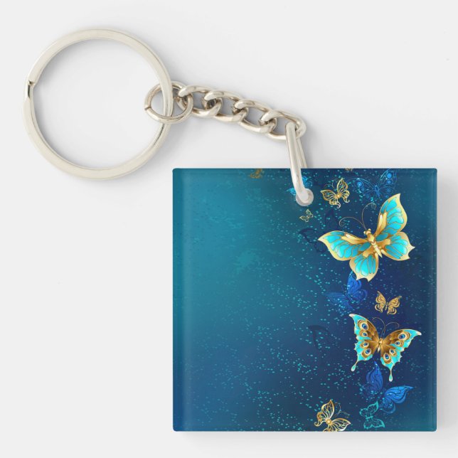 Goldene Schmetterlinge auf blauem Hintergrund Schlüsselanhänger (Vorderseite)