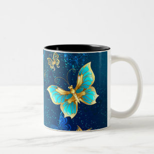Goldene Schmetterlinge auf blauem Hintergrund Zweifarbige Tasse