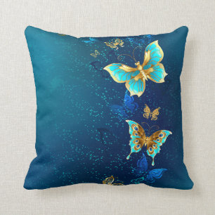 Goldene Schmetterlinge auf einem blauen Hintergrun Kissen