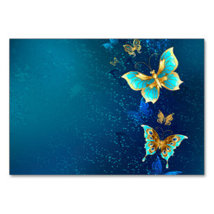 Goldene Schmetterlinge auf einem blauen Hintergrun Tischnummer