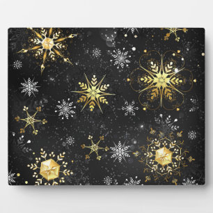 Goldene Schneeflocken auf schwarzem Hintergrund Fotoplatte