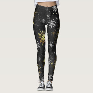 Goldene Schneeflocken auf schwarzem Hintergrund Leggings