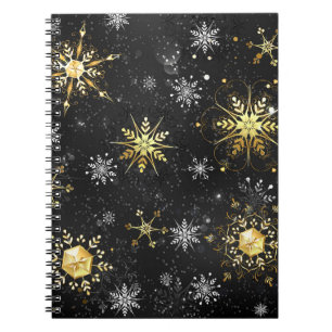 Goldene Schneeflocken auf schwarzem Hintergrund Notizblock