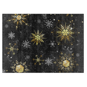 Goldene Schneeflocken auf schwarzem Hintergrund Schneidebrett