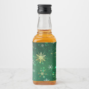 Goldene Schneeflocken im grünen Hintergrund Alkoholflaschenetikett