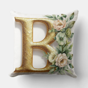 Goldener Buchstabe B umgeben von floralen Arrangem Kissen