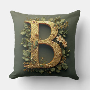 Goldener Buchstabe B umgeben von floralen Arrangem Kissen