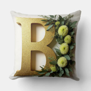 Goldener Buchstabe B umgeben von floralen Arrangem Kissen